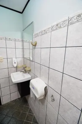 a bathroom with a sink and a mirror at Mangaby Playa Hermosa in Playa Hermosa