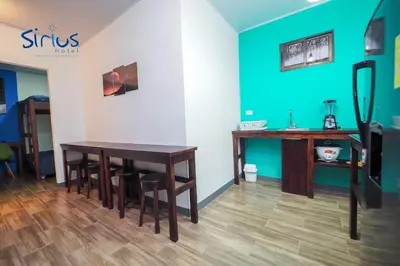 a room with a table and chairs and a blue wall at Hotel Sirius Costa Rica in San Mateo