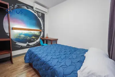 a bedroom with a bed with a painting on the wall at Hotel Sirius Costa Rica in San Mateo