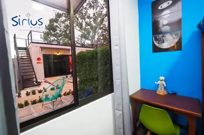 a room with a window with a table and chairs at Hotel Sirius Costa Rica in San Mateo