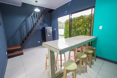 a dining room with a table and stools at Hotel Sirius Costa Rica in San Mateo