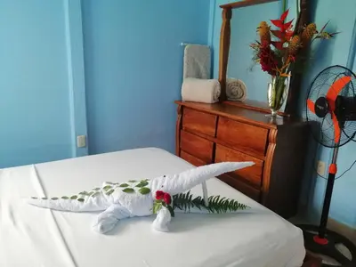 a stuffed shark on a bed in a room at Casa de Campo Heliconia in Fortuna