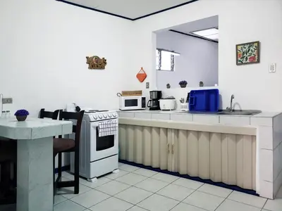 a kitchen with a sink and a stove top oven at Entire Comfy apartment for you, 5 min SJO Airport in Alajuela City