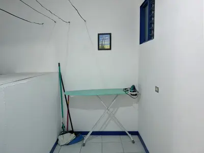 a table in a room with a white wall at Entire Comfy apartment for you, 5 min SJO Airport in Alajuela City