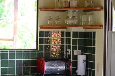 a kitchen with green tiles on the wall and a toaster at Montezuma Hills - Twin Houses in private compound - 4' to Downtown in Montezuma