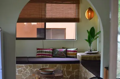 a living room with a bench and a window at Montezuma Hills - Twin Houses in private compound - 4' to Downtown in Montezuma