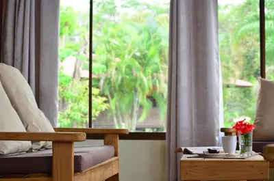 a room with a window with a couch and a chair at Montezuma Hills - Twin Houses in private compound - 4' to Downtown in Montezuma