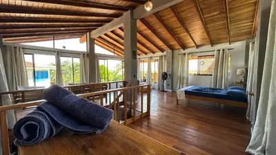 a room with a bed and towels on a table at Montezuma Hills - Twin Houses in private compound - 4' to Downtown in Montezuma
