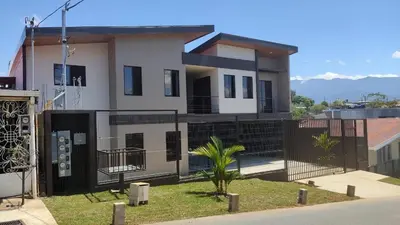 a house with a fence in front of it at Villas del General in San Isidro
