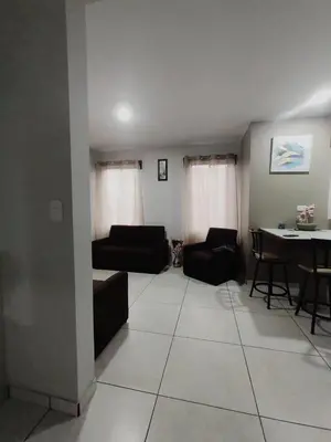 a living room with a couch and a dining room table at Villas del General in San Isidro