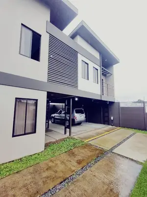 a car garage with a car parked in it at Villas del General in San Isidro