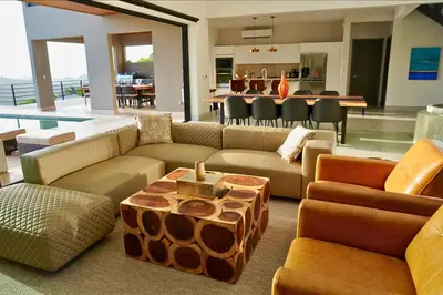 a large living room with couches and a table at Casa de Iluminacion - Gorgeous 5-BR oceanview Villa with private infinity Pool in Brasilito