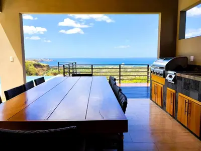a dining room with a table and a view of the ocean at Casa de Iluminacion - Gorgeous 5-BR oceanview Villa with private infinity Pool in Brasilito