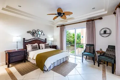 a bedroom with a bed and a large window at LUXURY 3BR appt, CENTER, 2 min to BEACH, hi-speed wifi in Tamarindo