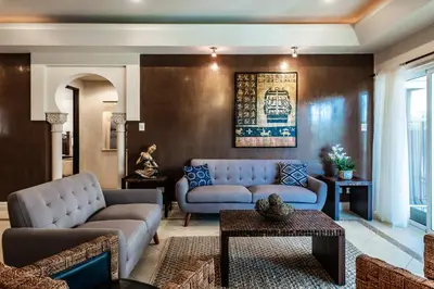 a living room with two couches and a table at LUXURY 3BR appt, CENTER, 2 min to BEACH, hi-speed wifi in Tamarindo