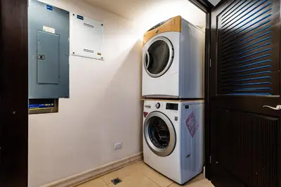 a laundry room with a washer and a dryer at LUXURY 3BR appt, CENTER, 2 min to BEACH, hi-speed wifi in Tamarindo
