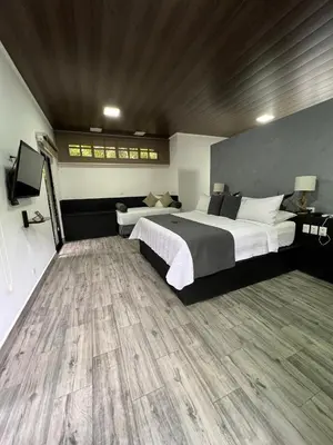 a bedroom with a large bed and a wooden floor at Hotel Boutique Casa Del Rio in Fortuna