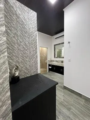 a large bathroom with a black counter and a sink at Hotel Boutique Casa Del Rio in Fortuna