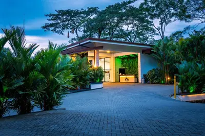 a house with a driveway and plants at Hotel Boutique Casa Del Rio in Fortuna
