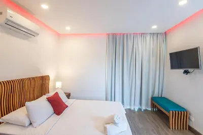 a hotel room with a bed and a television at Luxury Villa #9 De Los Pájaros in Playa Hermosa