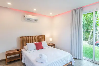 a bedroom with a bed with a stuffed animal on it at Luxury Villa #9 De Los Pájaros in Playa Hermosa