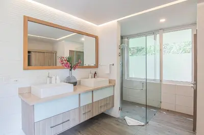 a bathroom with two sinks and a mirror at Luxury Villa #9 De Los Pájaros in Playa Hermosa