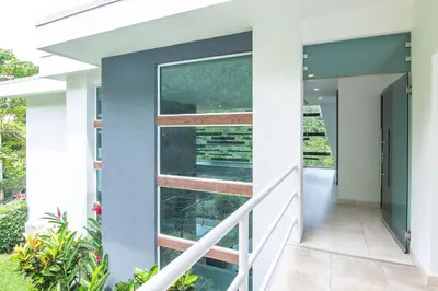 a pivot door in a house with a staircase at Luxury Villa #9 De Los Pájaros in Playa Hermosa