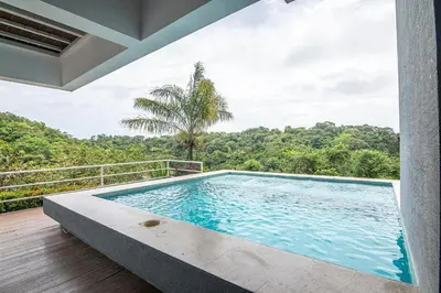 a swimming pool in the middle of a house at Luxury Villa #9 De Los Pájaros in Playa Hermosa