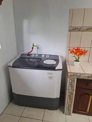 a small stove in a kitchen with a sink at Hospedaje Bosque del Río in Monteverde Costa Rica
