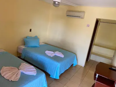 a room with two beds with bows on them at Hotel Real Alaska in Liberia