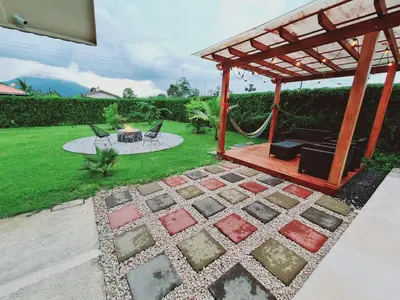 a patio with a gazebo and a hammock at Volcano view house la Fortuna in Fortuna