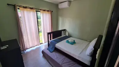 a bedroom with a bed with a teddy bear on it at Volcano view house la Fortuna in Fortuna