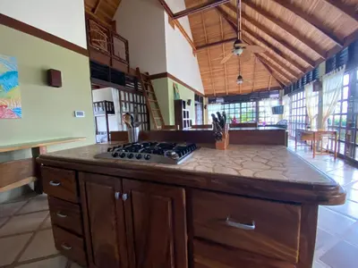 a kitchen with a stove top island in a room at Tropical Balinese Villa Atenas in Escobal