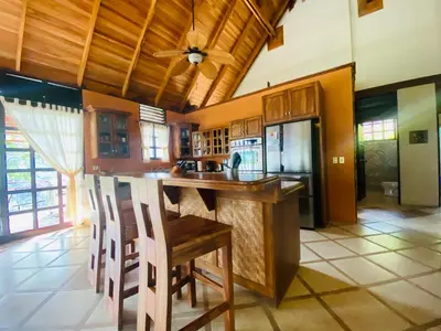 a kitchen with a center island with a counter top at Tropical Balinese Villa Atenas in Escobal