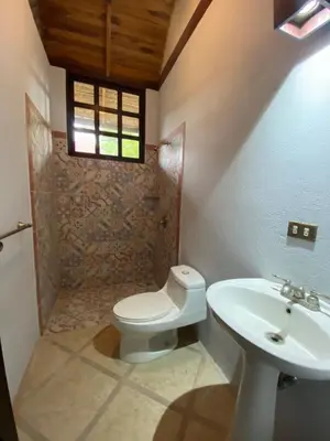 a bathroom with a toilet and a sink at Tropical Balinese Villa Atenas in Escobal