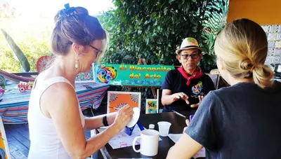 a group of people sitting at a table at Dreamcatcher House Bus Experience 2 in Sarchí