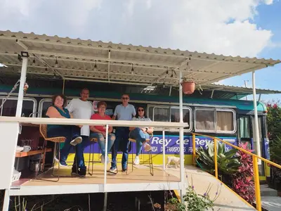 a group of people standing on the back of a bus at Dreamcatcher House Bus Experience 2 in Sarchí