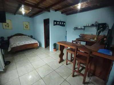 a bedroom with a desk and a bed and a table at Apartamento Siary 1 in Monteverde Costa Rica