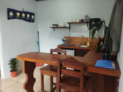 a kitchen with a wooden table and chairs at Apartamento Siary 1 in Monteverde Costa Rica