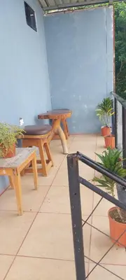 a patio with two picnic tables and potted plants at Apartamento Siary 1 in Monteverde Costa Rica