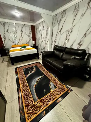 a living room with a couch and a bed at Caribbean View in Tortuguero