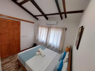 a bedroom with a bed and a window at Hotel Casa THIREMA Tortuguero in Tortuguero