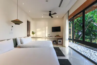 a bedroom with two beds and a large window at Luxury Beachfront Villa with private pool at Nantipa in Santa Teresa Beach