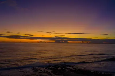 a sunset on the beach with the ocean at Luxury Beachfront Villa with private pool at Nantipa in Santa Teresa Beach
