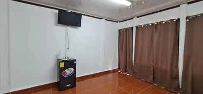 a room with white walls and brown curtains at Sleep&Go! Cabina Cuadruple en Siquirres Centro - and rafting tour! in Siquirres