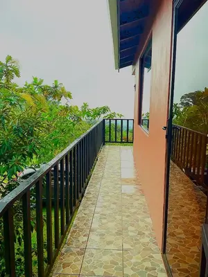 a balcony of a house with a walkway at Casa de Montaña Tica Linda in Monteverde Costa Rica