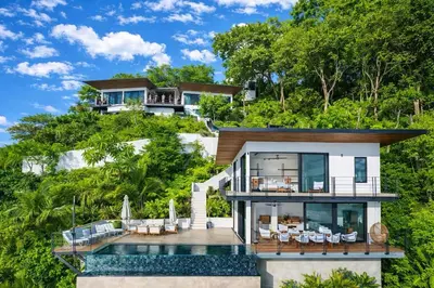 a house on a hill with a swimming pool at Seataya Villas in Santa Teresa Beach