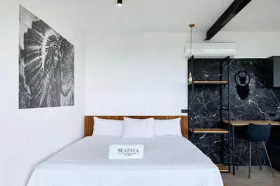 a bedroom with a white bed with a sign on it at Seataya Villas in Santa Teresa Beach