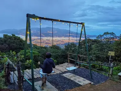 a person sitting on a swing at a park at Escapadita al Bosque in San Isidro