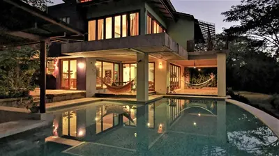a house with a swimming pool in front of a house at Villa Carlotta in Respingue